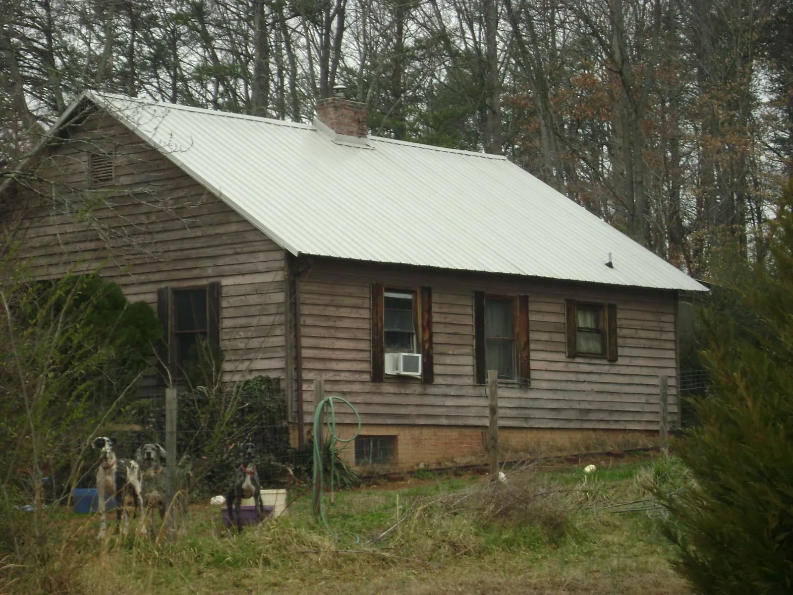 White metal roof on an old wood sided farmhouse, from a Metal Roof Installation job in Pendergrass